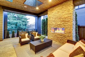 Luxury deck modern exterior with stone fireplace and wooden ceiling